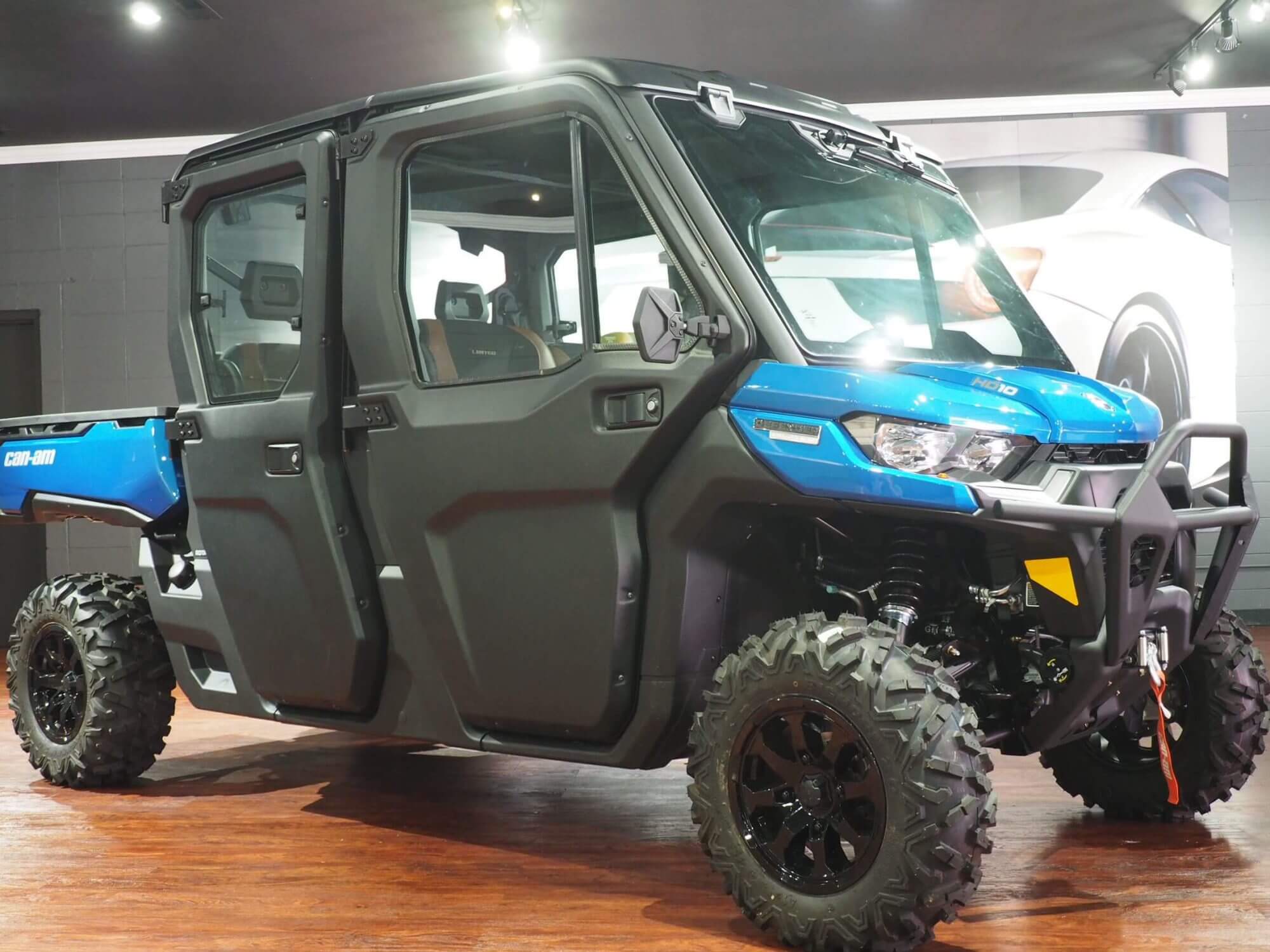 Blue Defender UTV showcased on hardwood floor